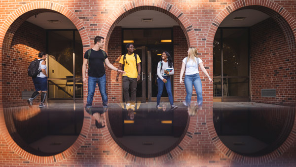 A group of students talking together outside