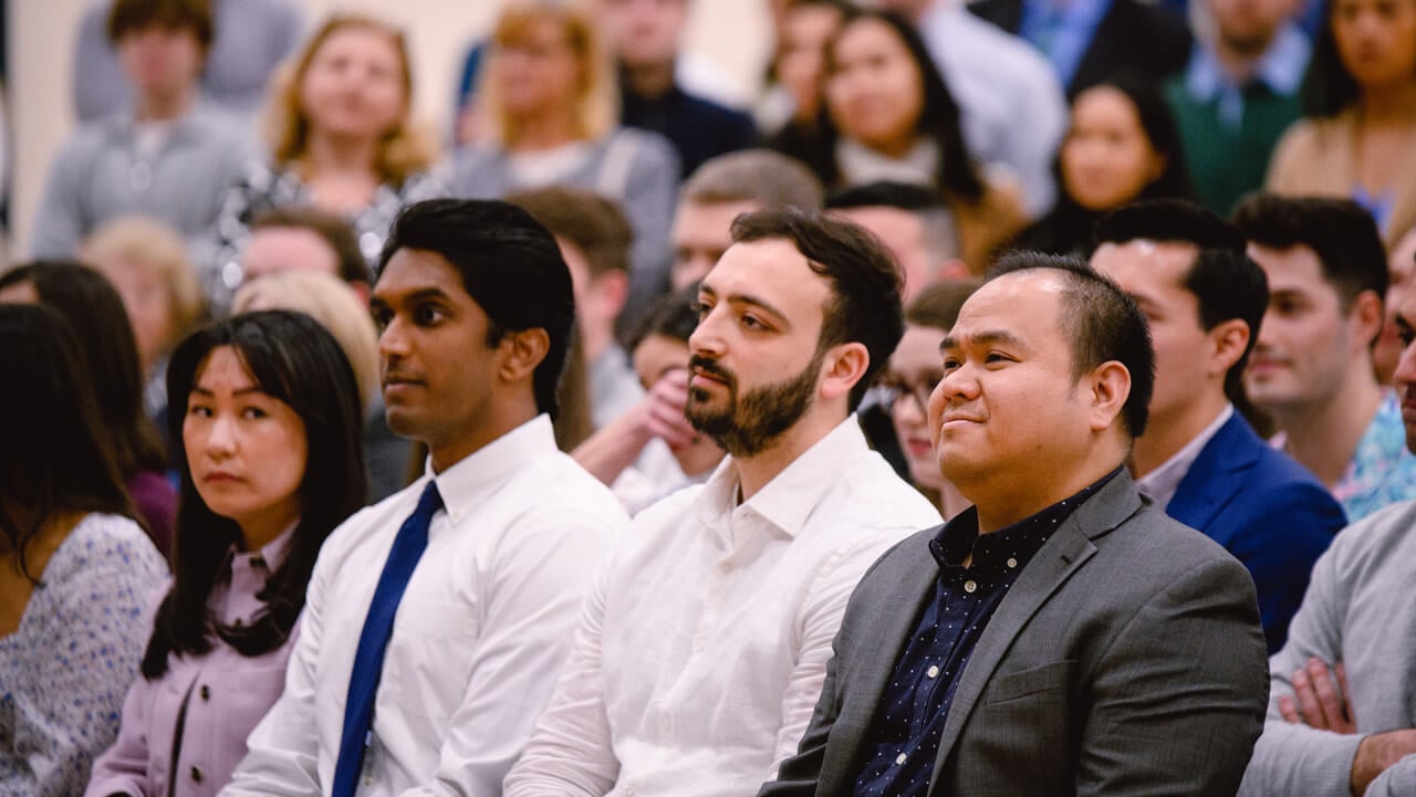 Graduates listening to match day commencement