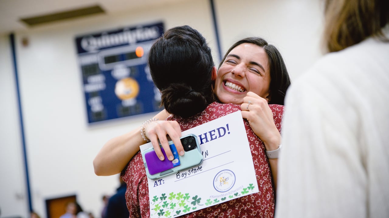 Graduate and family member hugging each other