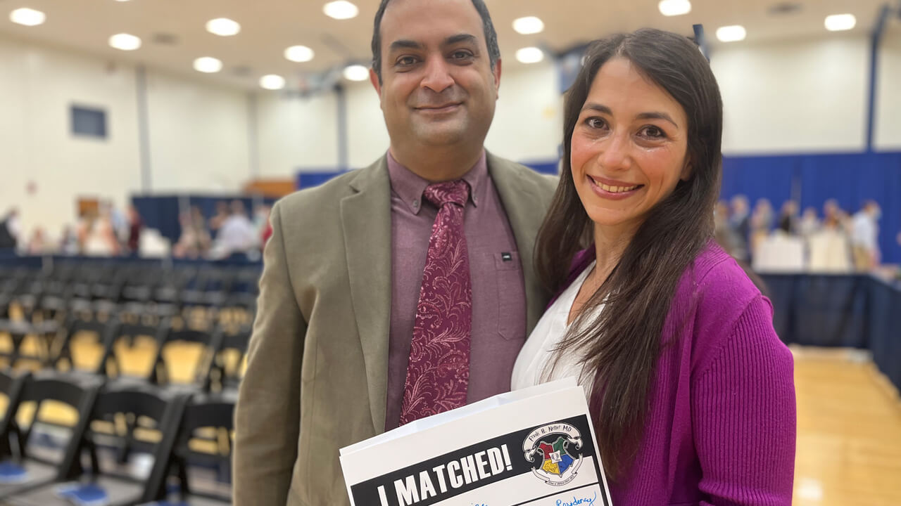 Sheila Eghbali smiles while holding her residency match sign