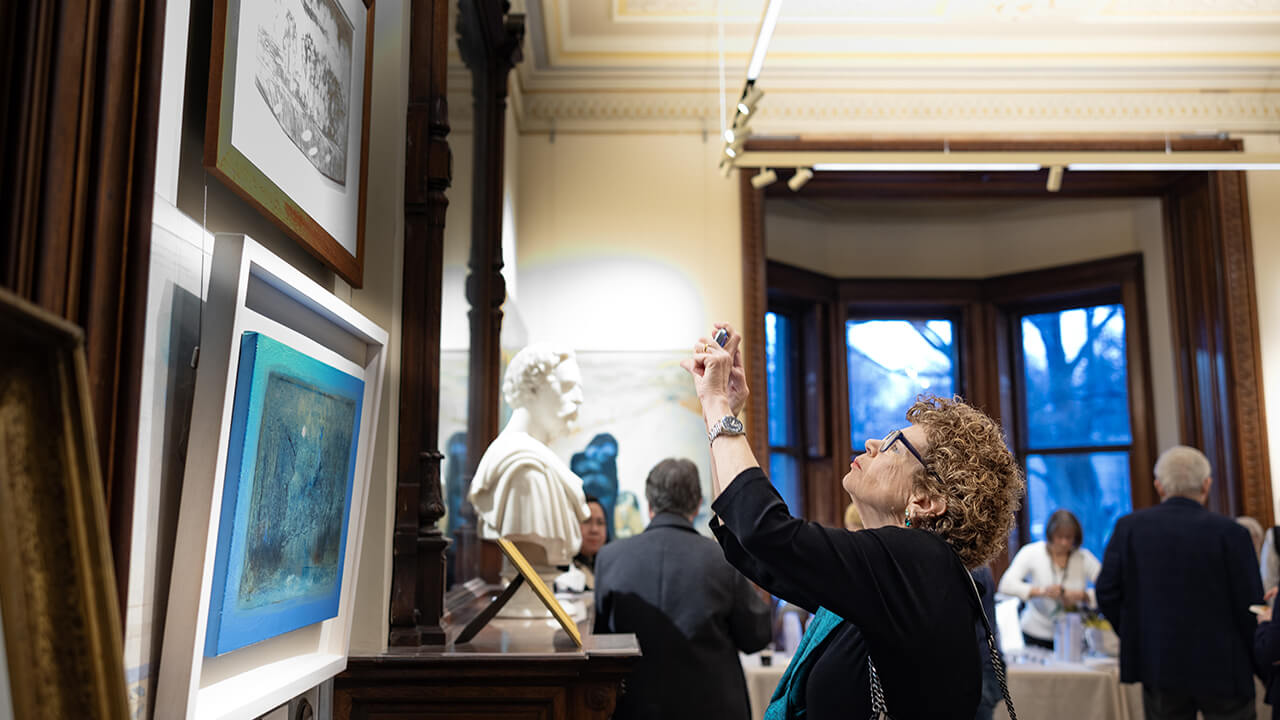 Community member taking photo of pieces in the Ireland Great Hunger Museum