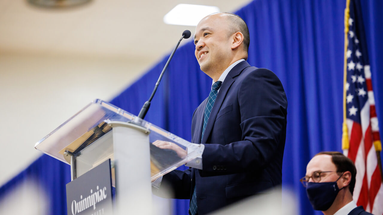 Steve Paik speaks at a podium during the Match Day celebration