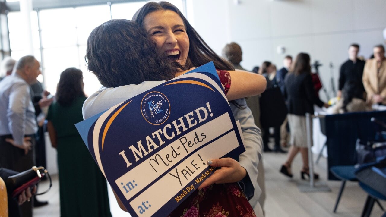 students hugging and celebrating on match day