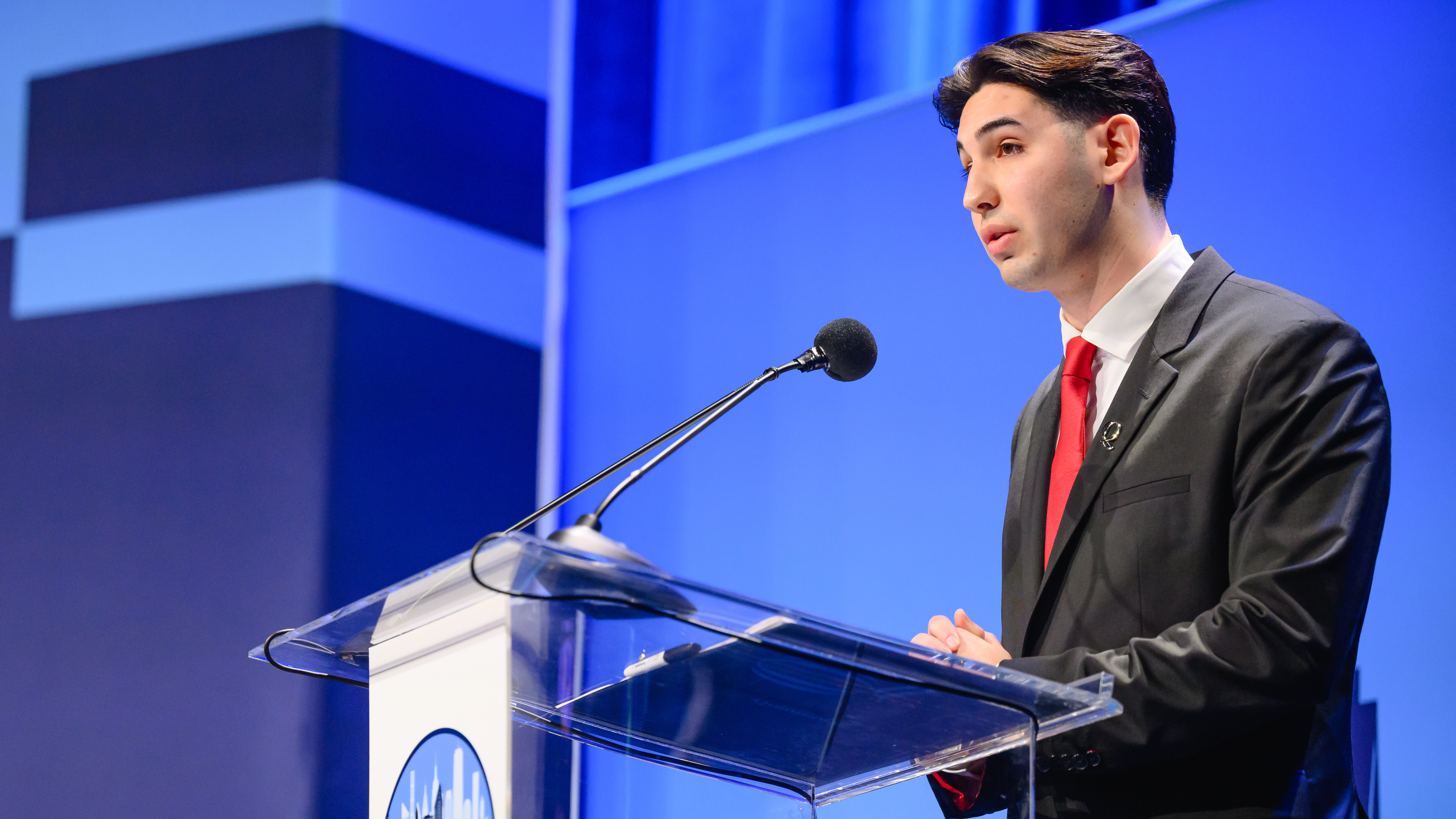 Speaker at podium at 15th annual Global Asset Management Education Forum in New York