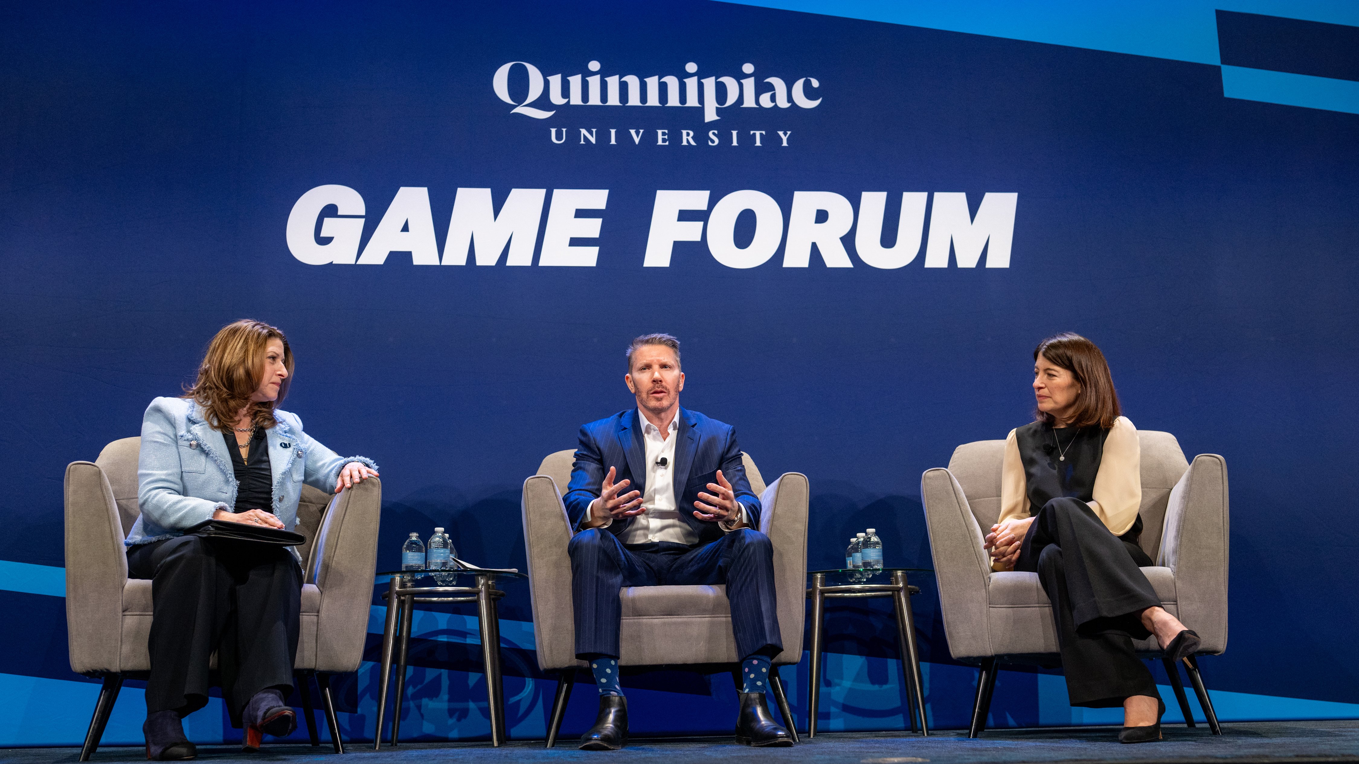 Seated panel side photo at 15th annual Global Asset Management Education Forum in New York