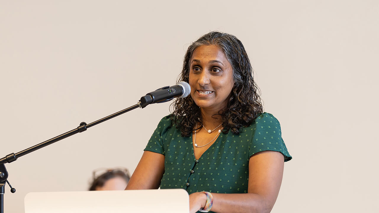 Person speaking to medical students before opening their Matches