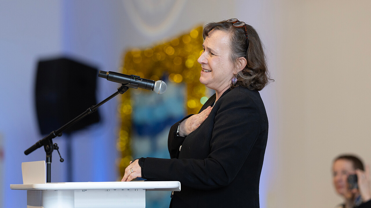 Individual speaking to the medical students before they open their Match Day envelopes