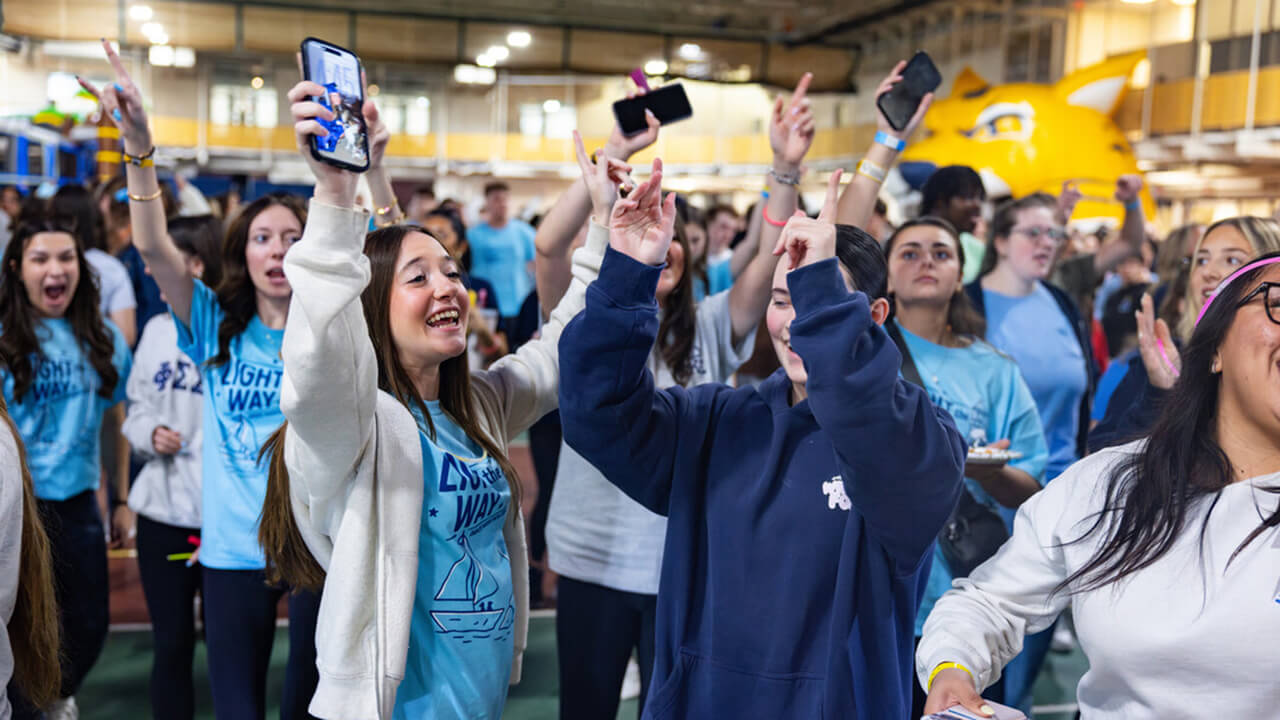 Students participating in QTHON celebrate with smiles and cheer