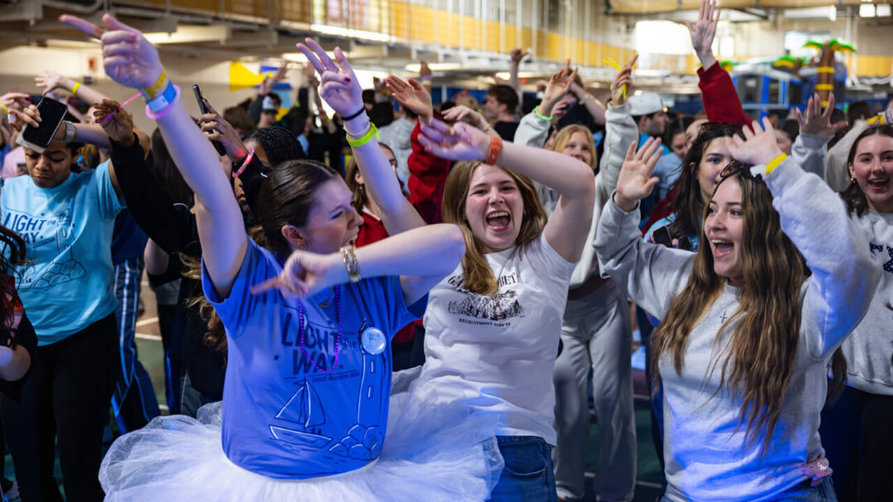 QTHON participants dance around in the gym to celebrate QTHON activities