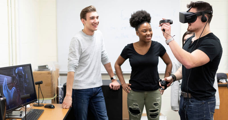 3 students participating in a Game Design and Development class