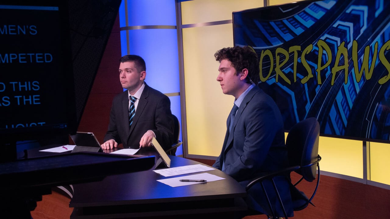 Clever and Joey live on air at the desk in the new q30tv studio