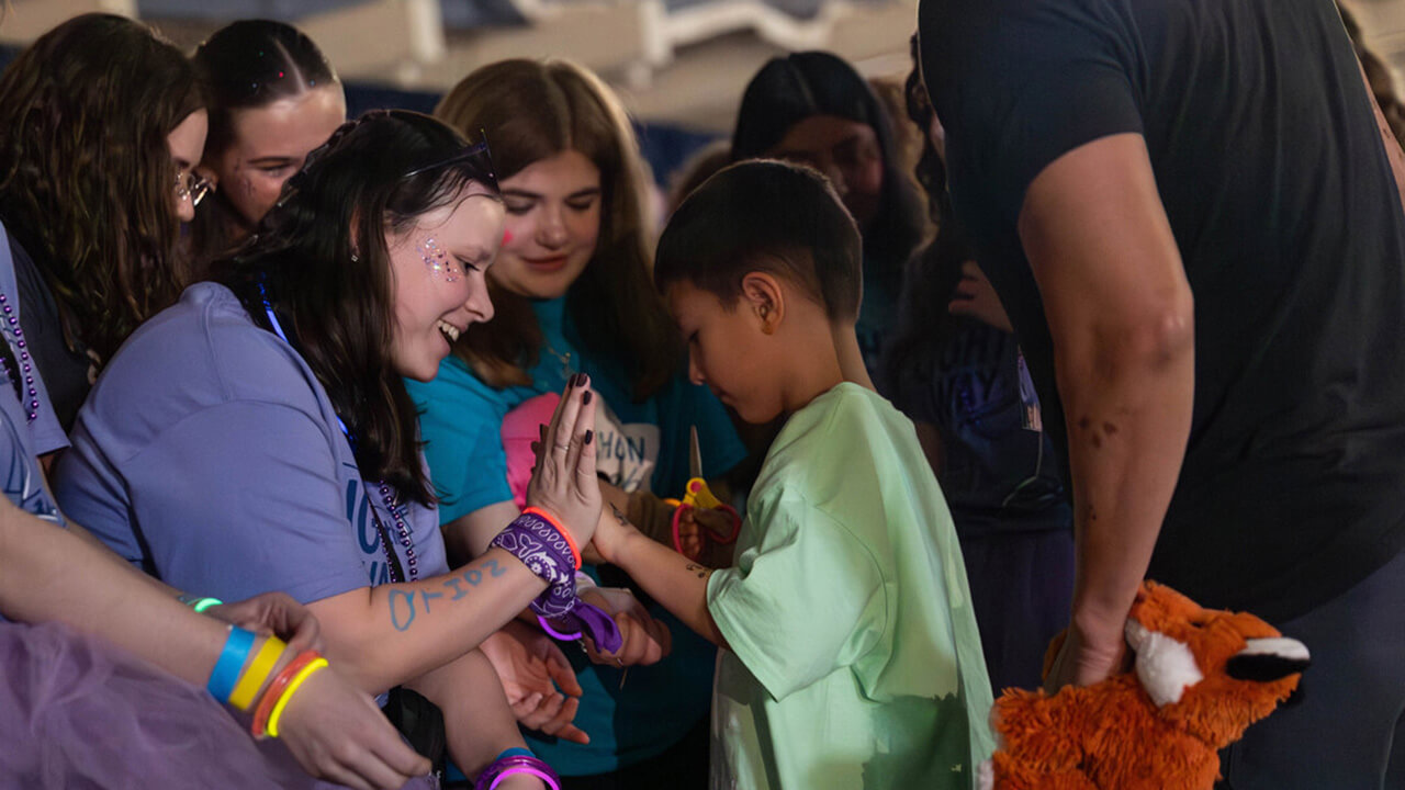 Students share moment with miracle child at QTHON