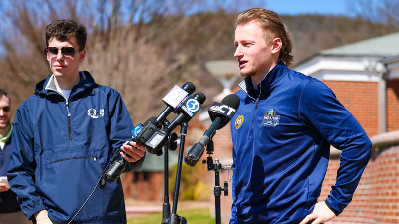 Men's ice hockey team captain speaks with members of the news media