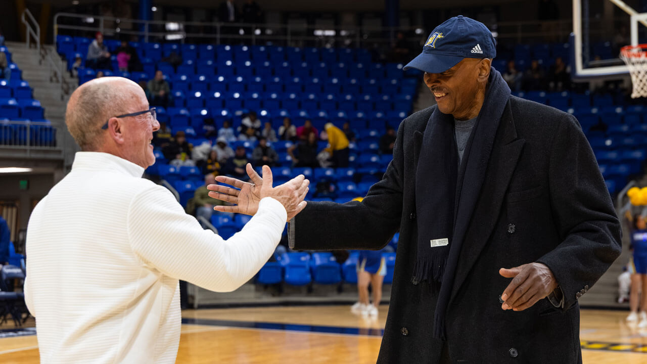 Two men going in for a handshake