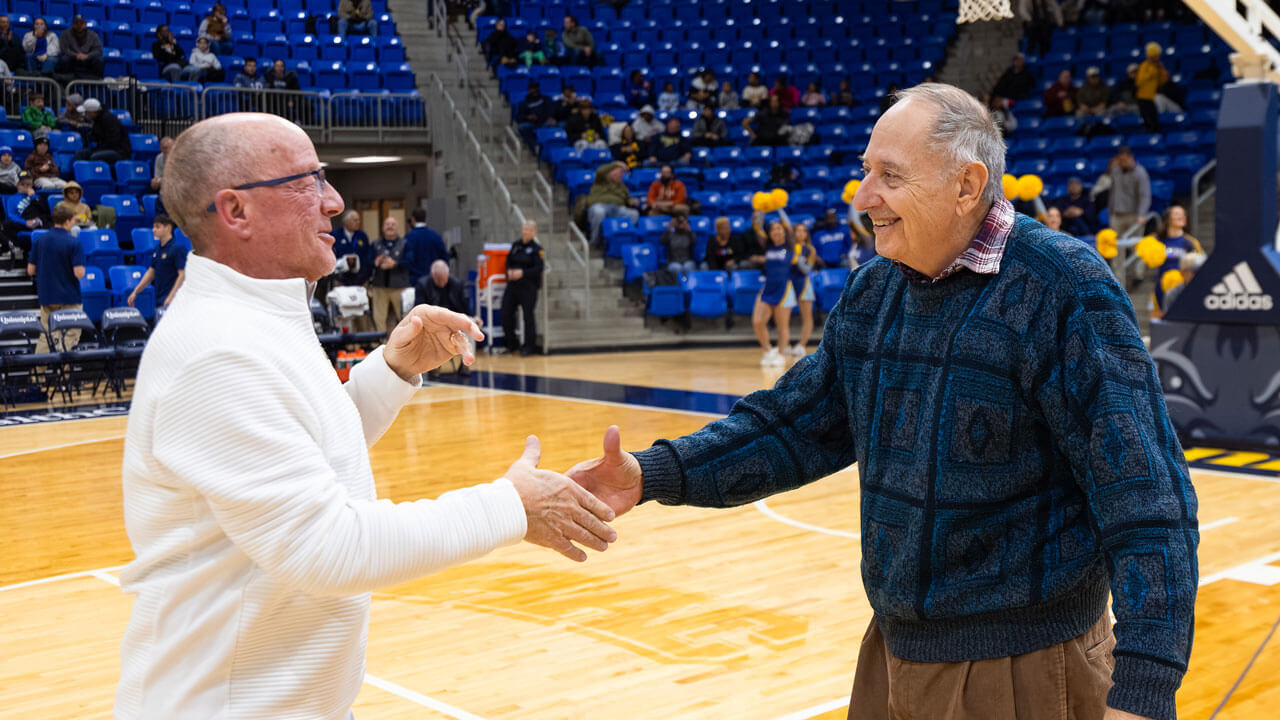 On the court at M&T Bank Arena, two men share a handshake