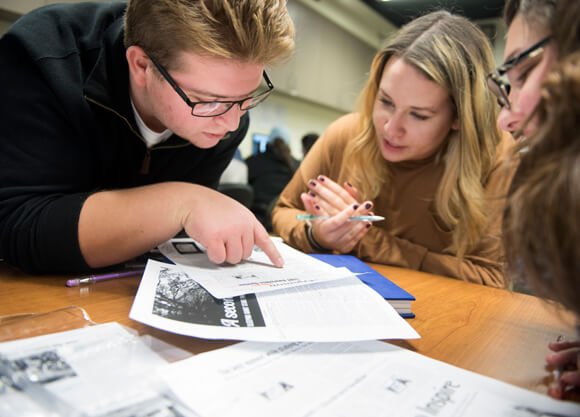 Student writers edit headlines during a meeting