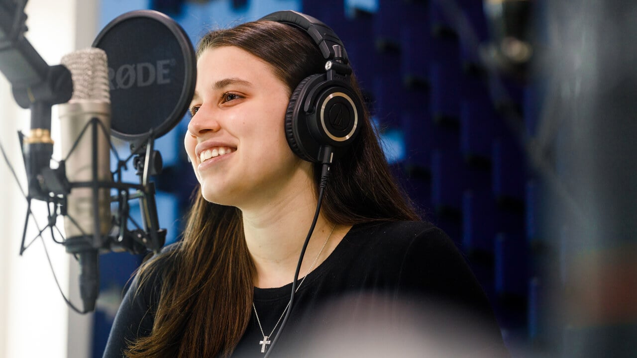 Student participates in a podcast recording session.