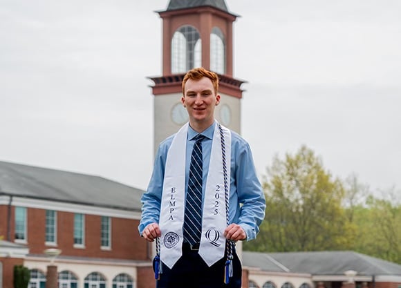 Aidan Hanley posing for a photo on the quad
