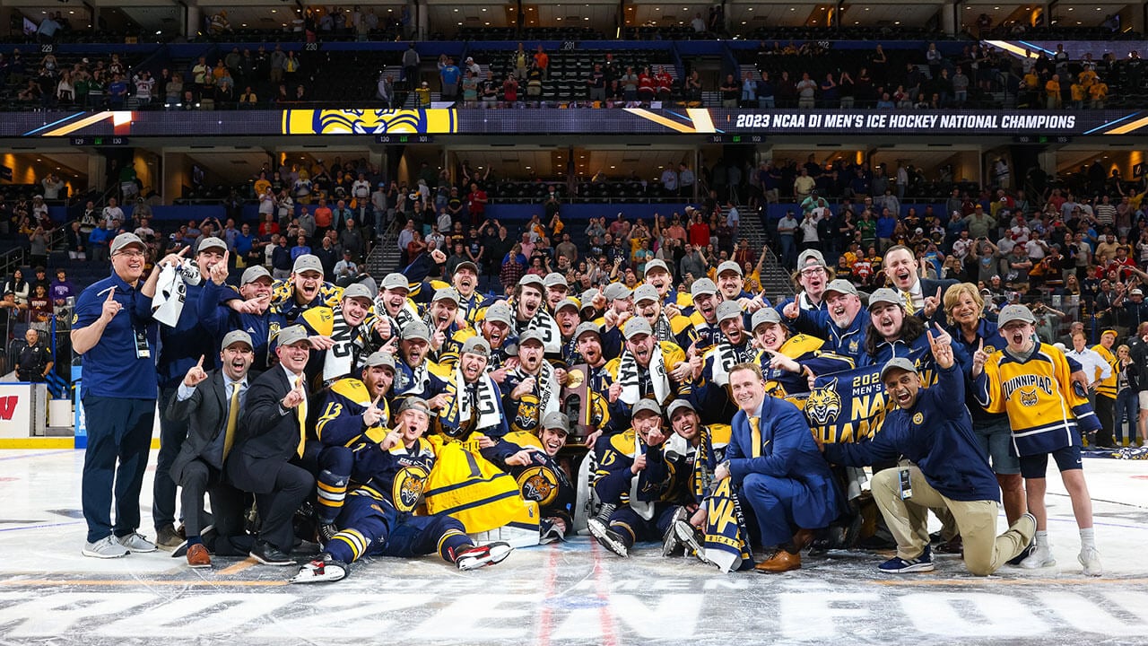 Men's ice hockey team with their trophy