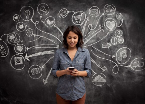 Woman stand in front of chalkboard with writing