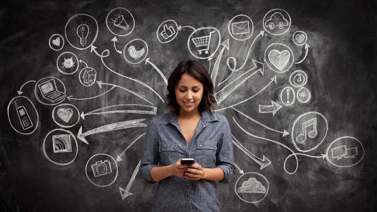 Woman stand in front of chalkboard with writing