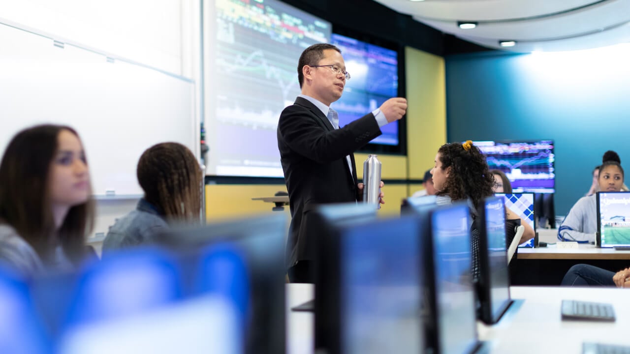 Professor teaching in the Lender School of Business financial center.