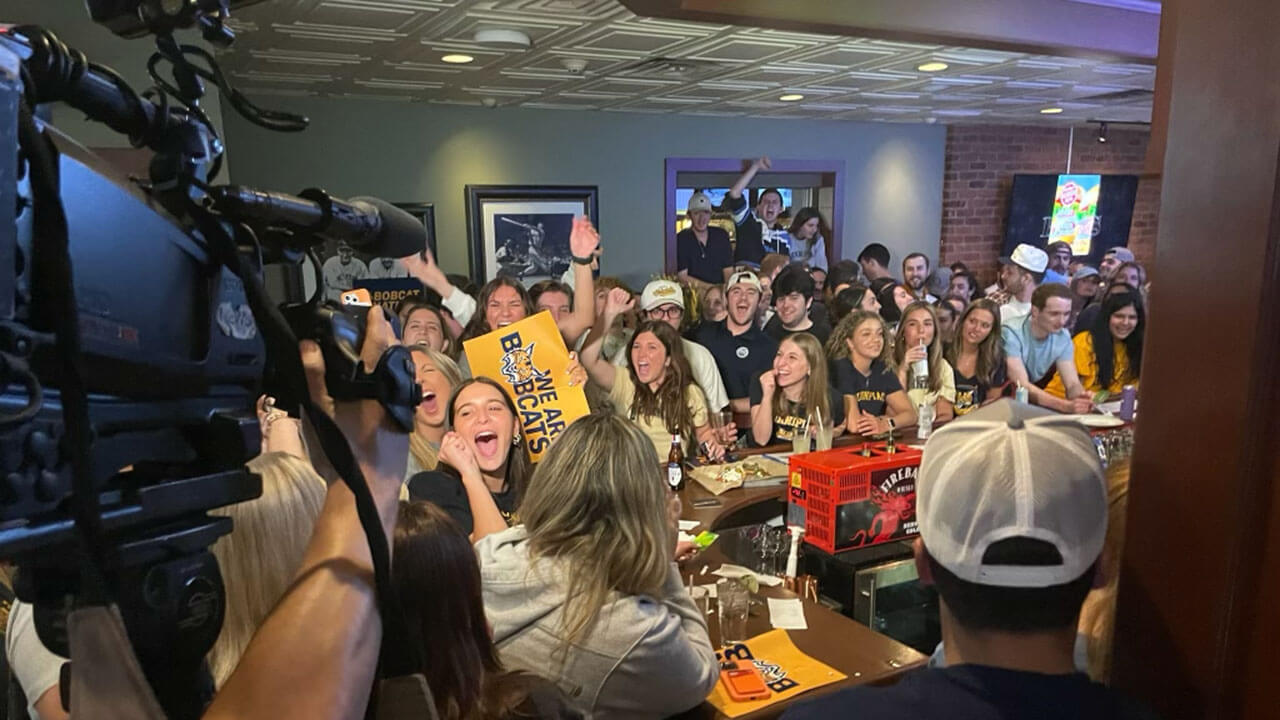 Students & alumni watch the game at a watch party in Hamden, CT