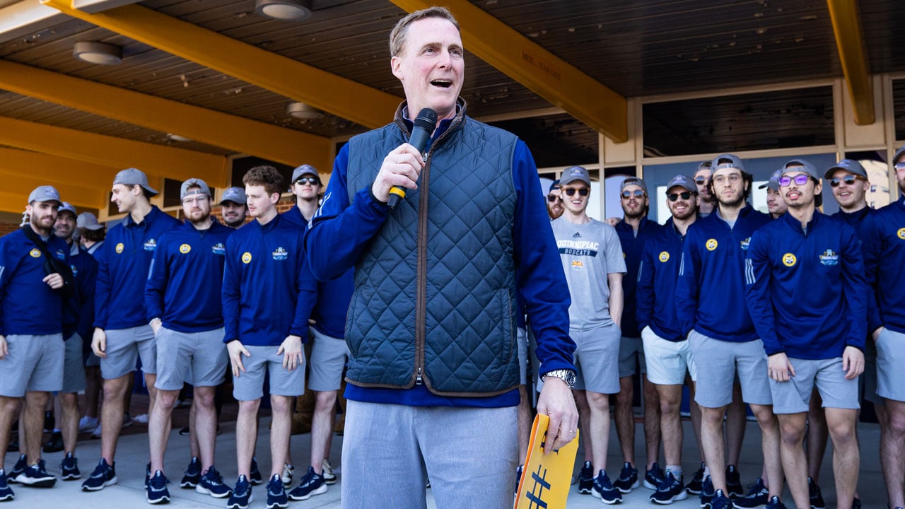 Coach gives speech in front of hockey team