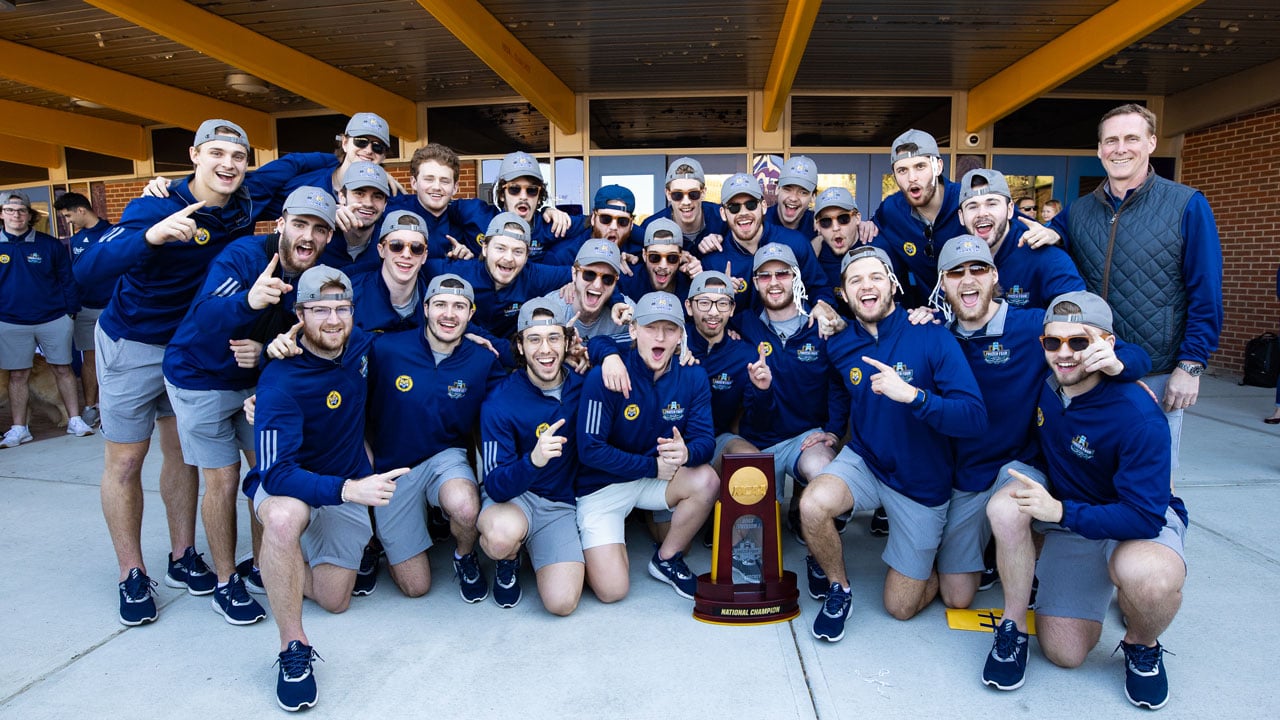 Hockey team posing and smiling for photo