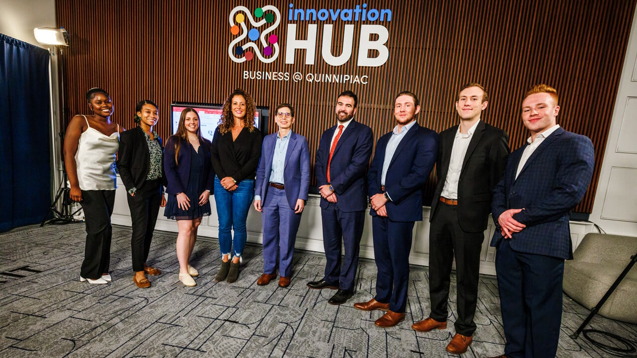 Students posing for a group photo in the Innovation Hub