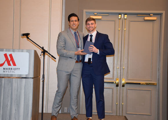 Alec Williams accepts his Pa Student of the Year award on stage