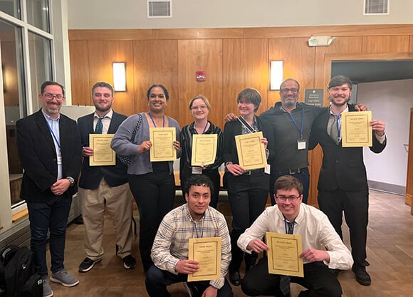 Group of students with awards at computer science conference
