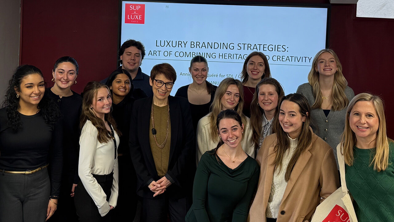 Study abroad group gathered in front of a tour of the Sup Luxe branding facilities