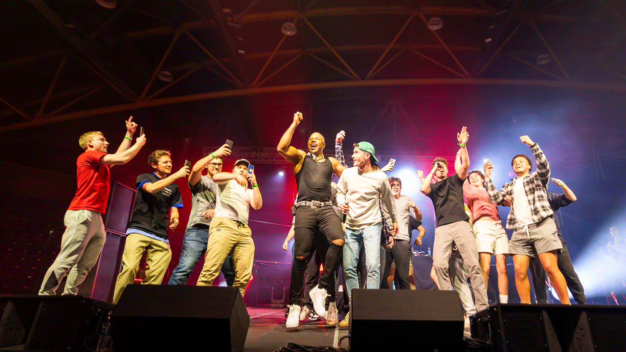 Flo Rida invites students on stage to preform with him and they all sign and dance