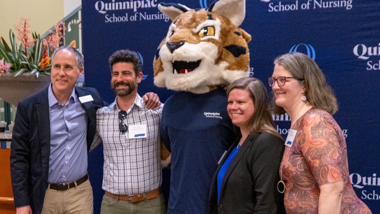 Attendees pose with Boomer