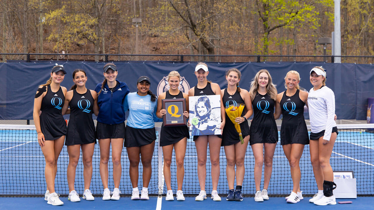 Student athletes smile together on the Peter Liberti Tennis Complex