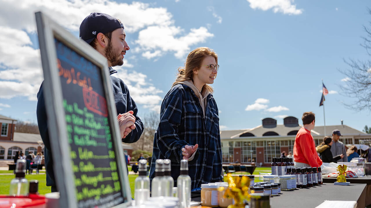 A student showcases her merchandise.