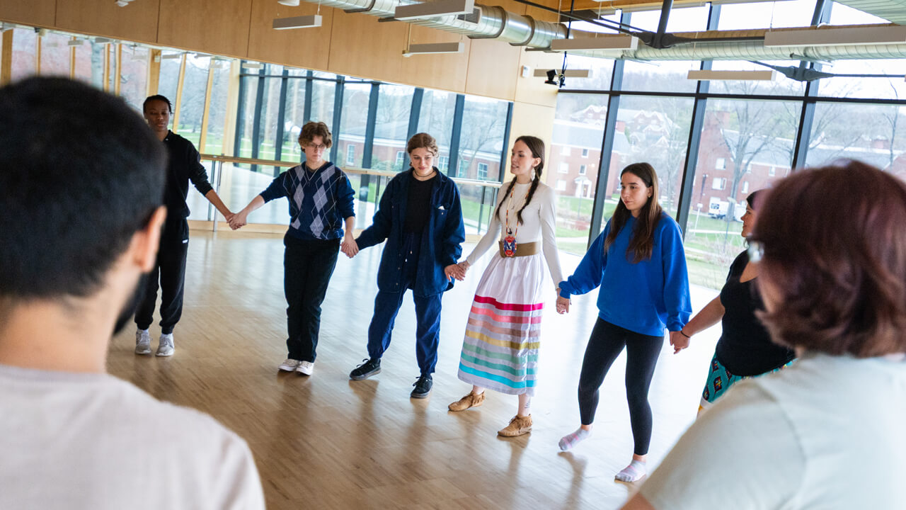 A group of people holding hands in a circle