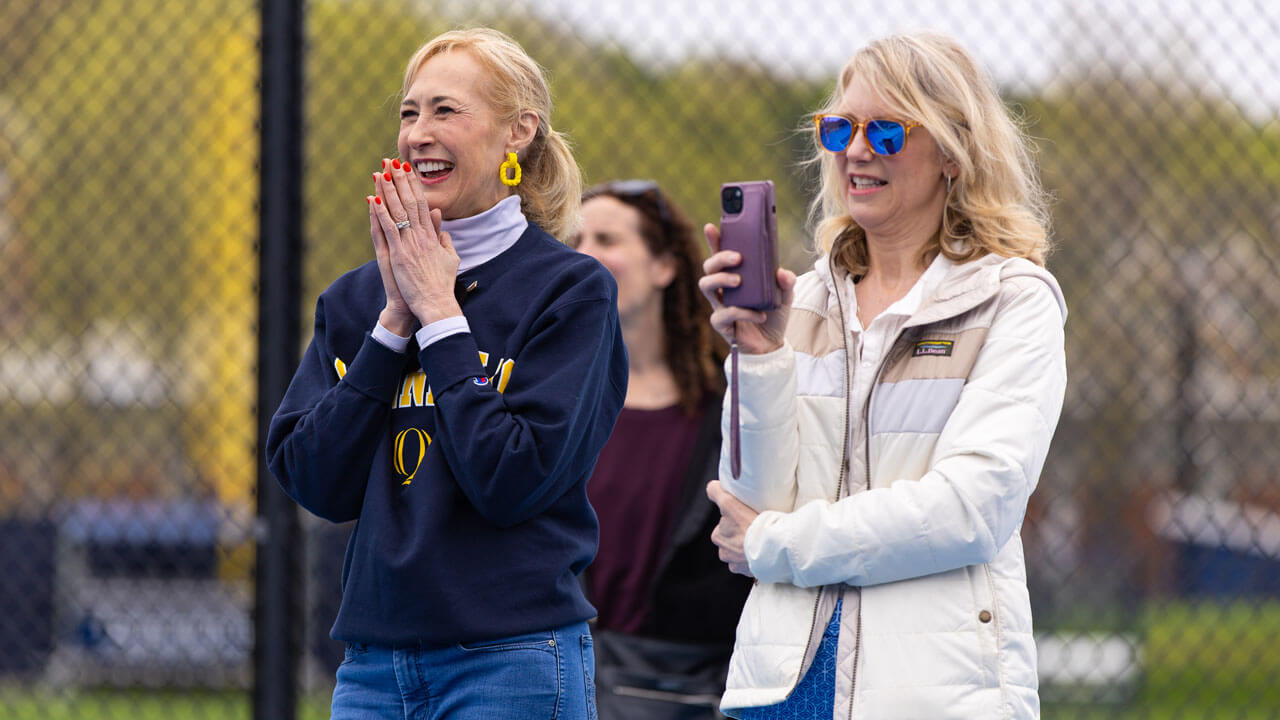 President Marie Hardin clapping at the Peter Liberti Tennis Complex ceremony