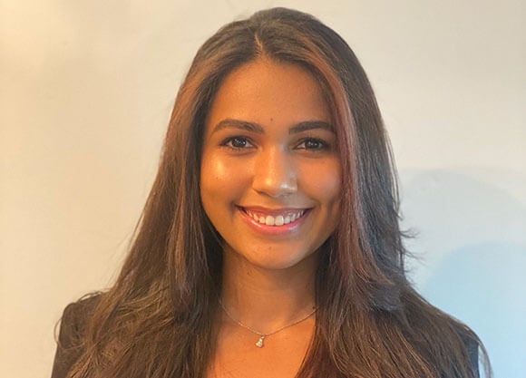 Chelsea Hiciano smiles in front of a white background