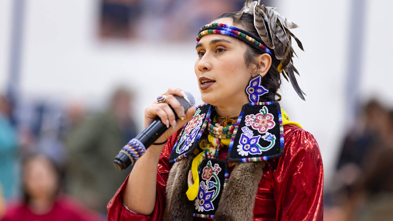 A performer speaks to a crowd at the Shadow of Sleeping Giant Powwow held at Quinnipiac