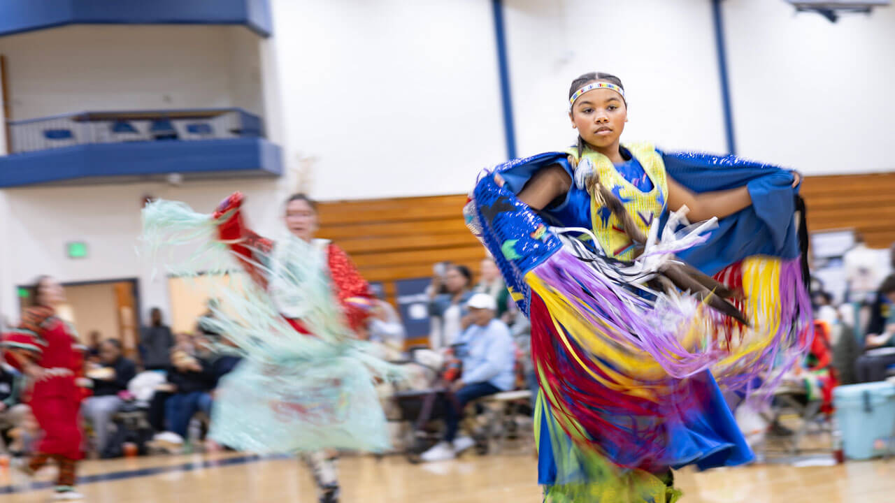 Performers dance in traditional regalia at the Dancing in the Shadow of Sleeping Giant Powwow held at Quinnipiac