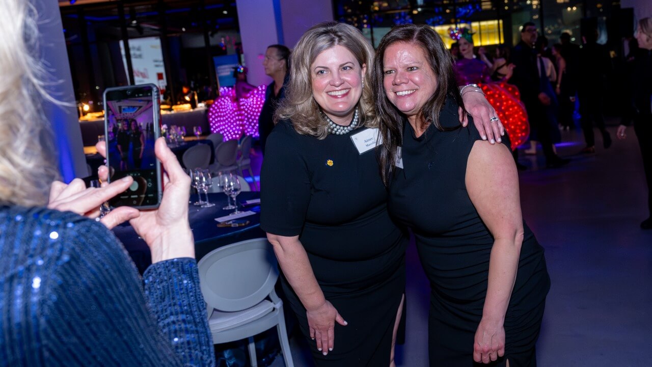 Two individuals taking a photo together at the Quinnipiac Gala