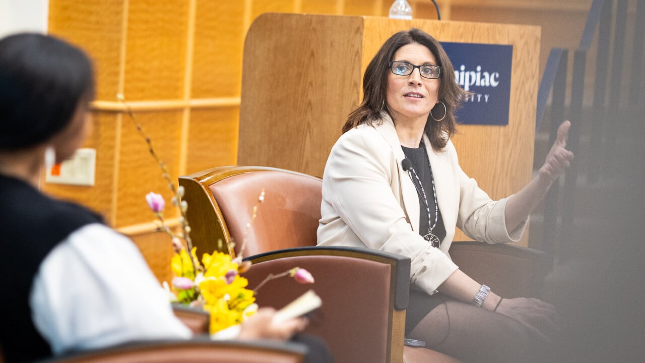 Sarah Harris looking to Jennifer Rawlings as she speaks while sitting