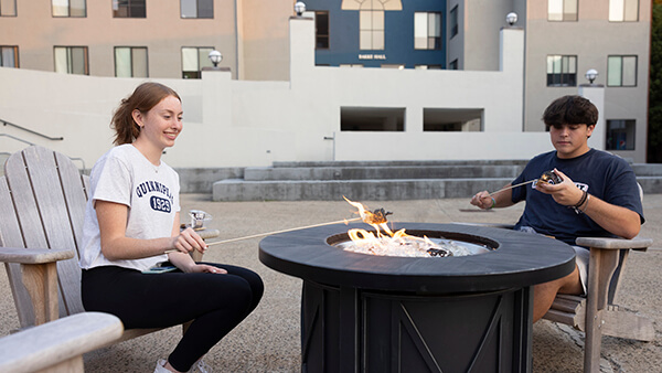 Students talking and sitting around the fire pits