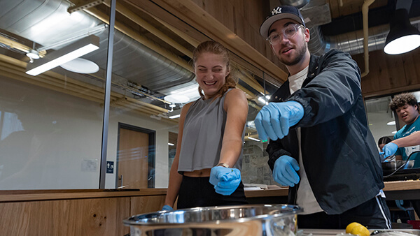Students collaborating together in the demonstration kitchen