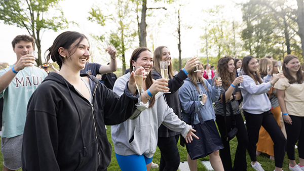 Students toasting glasses of champagne at the graduation class toast