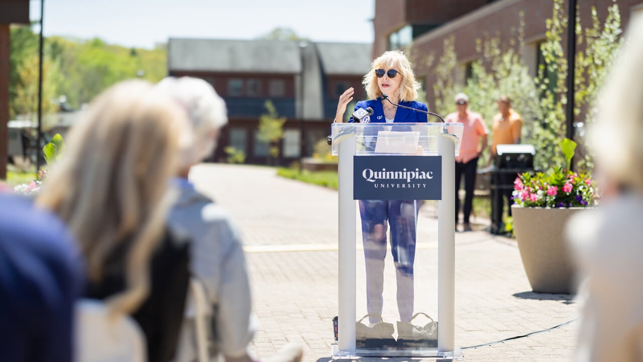 President Judy Olian speaks at a podium