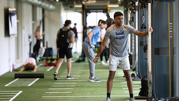 Students use RecWell equipment during workout
