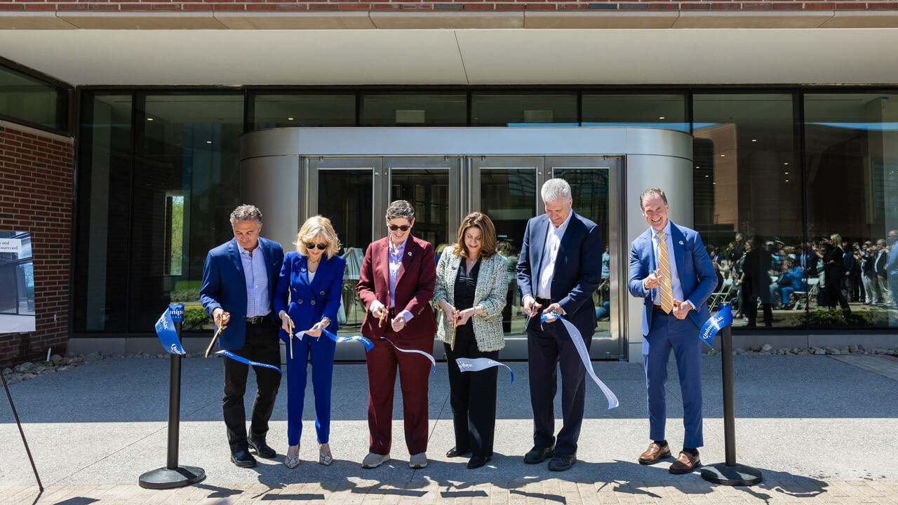 Group cuts a ribbon